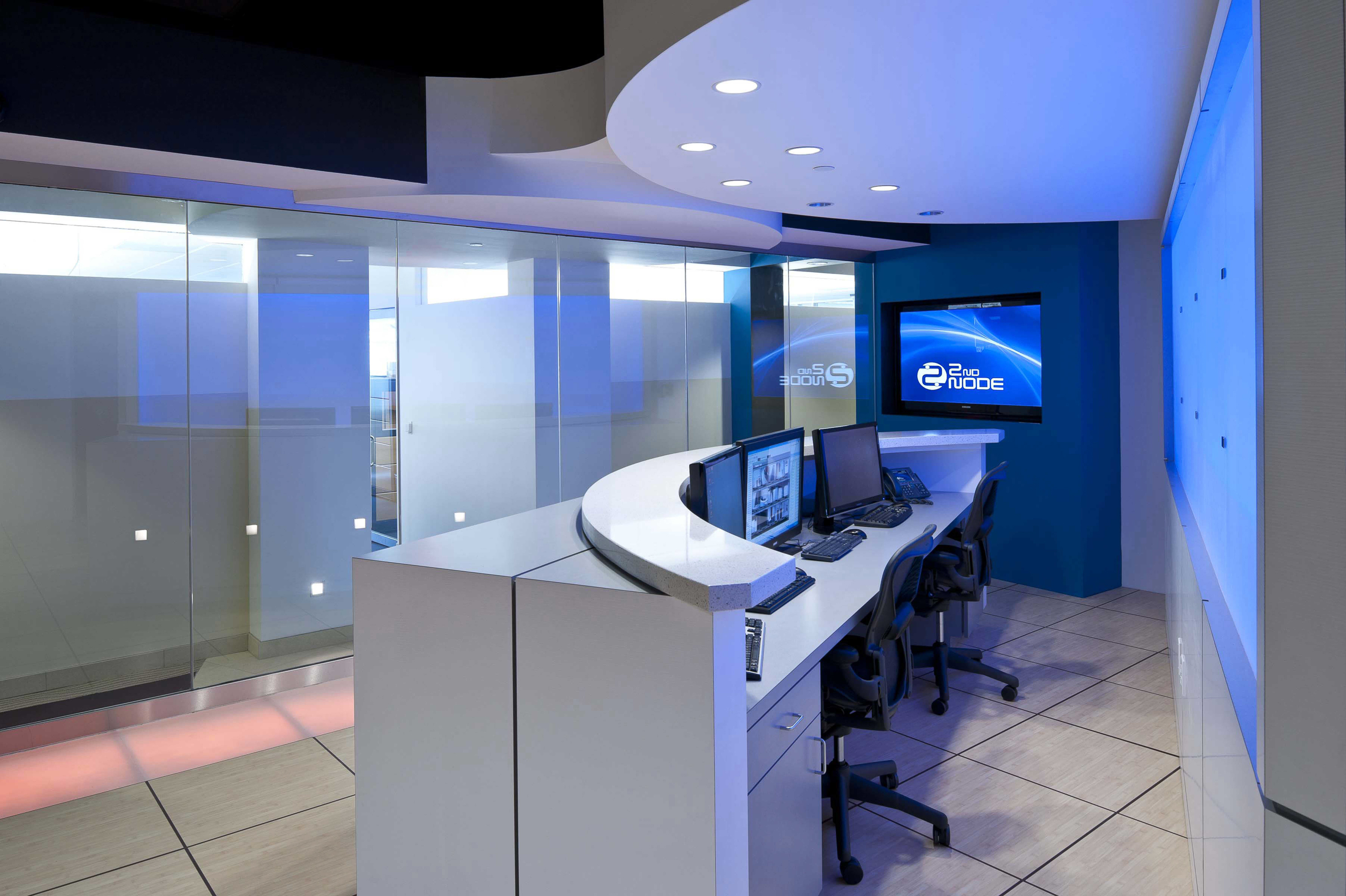 2nd node lobby with glass doors and a desk with blue lights